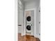 Hallway view of a stacked washer and dryer with white appliances at 49 Ashley Ave, Charleston, SC 29401