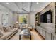 Open living area with gray shelving unit, recessed lights, ceiling fan, and neutral furniture at 49 Ashley Ave, Charleston, SC 29401