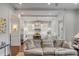Bright, open living space flowing into gourmet kitchen featuring white cabinets and stainless appliances at 49 Ashley Ave, Charleston, SC 29401