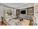 Living room with a large window, recessed lighting, and a gray built in entertainment center at 49 Ashley Ave, Charleston, SC 29401