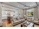 Bright, open living space featuring hardwood floors, a ceiling fan and an open flow into the gourmet kitchen at 49 Ashley Ave, Charleston, SC 29401