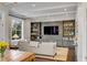 Living room showcasing custom built-ins, hardwood floors, and natural light at 49 Ashley Ave, Charleston, SC 29401