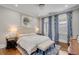 The main bedroom has blue patterned curtains, rug and a bench at the end of the bed at 49 Ashley Ave, Charleston, SC 29401