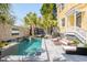 Beautiful backyard pool area with waterfall feature, lounge chairs, and well-manicured landscaping at 49 Ashley Ave, Charleston, SC 29401