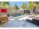 Outdoor pool and patio area with a water feature, lounge chairs, and lush landscaping at 49 Ashley Ave, Charleston, SC 29401