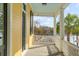 Charming yellow porch with black shutters and a view of the waterfront at 49 Ashley Ave, Charleston, SC 29401
