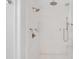 Shower with white tile, showerheads, and glass door at 49 Ashley Ave, Charleston, SC 29401