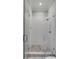 Modern shower with glass doors, white subway tile, and hexagon tile floor at 49 Ashley Ave, Charleston, SC 29401