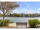 Picturesque view of a lake with a bench, surrounded by trees and charming neighborhood at 49 Ashley Ave, Charleston, SC 29401