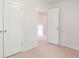 Bright bedroom with white walls and plush carpeting, features hallway and closet doors at 551 Gahagan Rd, Summerville, SC 29486