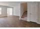 The staircase area of a new home is shown with wood-look floors on the first level and carpet on the stairs at 551 Gahagan Rd, Summerville, SC 29486
