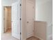 Upstairs hallway featuring white doors, neutral walls, and easy access to a closet and other rooms at 557 Gahagan Rd, Summerville, SC 29486