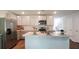 Bright kitchen features stainless steel appliances, island with sink, and ample cabinet space at 557 Gahagan Rd, Summerville, SC 29486