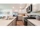 Modern kitchen with stainless steel appliances, gas range, and stylish gray cabinets at 557 Gahagan Rd, Summerville, SC 29486
