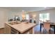 Open-concept living area with kitchen island, living room, and dining table with natural light at 559 Gahagan Rd, Summerville, SC 29486