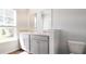 Bathroom with double sink vanity, two mirrors, exterior window and tiled floors at 561 Gahagan Rd, Summerville, SC 29486