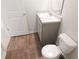 Bathroom features a sink with a mirror, toilet, and wood flooring at 561 Gahagan Rd, Summerville, SC 29486