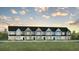 Charming new townhomes with modern design features and colorful exteriors under a cloudy sky at 561 Gahagan Rd, Summerville, SC 29486
