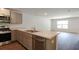 Modern kitchen with stainless steel appliances, gray cabinets and an island with a stainless steel sink at 561 Gahagan Rd, Summerville, SC 29486