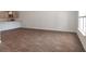 A view of the kitchen and living room with wood-look flooring and a large window at 561 Gahagan Rd, Summerville, SC 29486