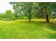 Expansive backyard featuring well-maintained lawn and mature trees, perfect for outdoor activities and relaxation at 5823 Lakeview Dr, Hanahan, SC 29410