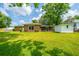Charming brick home with a screened-in porch, situated on a well-manicured lawn with mature trees at 5823 Lakeview Dr, Hanahan, SC 29410