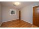Simple bedroom offers wood floor, neutral paint, and a window at 5823 Lakeview Dr, Hanahan, SC 29410
