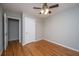 A bright bedroom featuring hardwood floors and a ceiling fan with lighting at 5823 Lakeview Dr, Hanahan, SC 29410