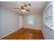 Comfortable bedroom with hardwood flooring, bright window, and a ceiling fan with lighting at 5823 Lakeview Dr, Hanahan, SC 29410