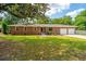 Charming brick home with a well-manicured lawn and attached two-car garage at 5823 Lakeview Dr, Hanahan, SC 29410