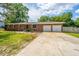 Traditional brick home featuring a two-car garage and a concrete driveway at 5823 Lakeview Dr, Hanahan, SC 29410