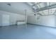 Spacious garage featuring a storage cabinet and painted floor ready for vehicles or projects at 5823 Lakeview Dr, Hanahan, SC 29410