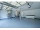 Spacious garage features painted floors and walls, ample storage cabinets, and an overhead door with modern opener at 5823 Lakeview Dr, Hanahan, SC 29410