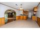 Bright kitchen and dining area with wood cabinets, stylish flooring and wood paneled accent walls at 5823 Lakeview Dr, Hanahan, SC 29410