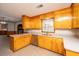 Bright kitchen features wood cabinets, modern appliances, and views into other living areas at 5823 Lakeview Dr, Hanahan, SC 29410
