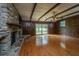 Cozy living room with a stone fireplace, wood paneling and a sliding glass door at 5823 Lakeview Dr, Hanahan, SC 29410