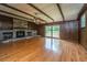 Spacious living room featuring a stone fireplace, wood paneled walls, and a ceiling fan at 5823 Lakeview Dr, Hanahan, SC 29410