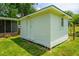 A backyard storage shed, freshly painted, providing additional space for tools and equipment with a small window at 5823 Lakeview Dr, Hanahan, SC 29410