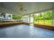 Enclosed sunroom with brick walls, windows, and a ceiling fan offers a pleasant view at 5823 Lakeview Dr, Hanahan, SC 29410