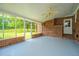 Enclosed sunroom with brick walls, windows, and a ceiling fan with views of the yard at 5823 Lakeview Dr, Hanahan, SC 29410