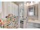 Bright bathroom featuring a vanity with white countertops, a mirror, and a shower with decorative curtain at 6279 Lucille Dr # B, North Charleston, SC 29406