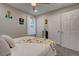 Bright bedroom with a ceiling fan, a closet, a window and a comfortable bed with decorative pillows at 6279 Lucille Dr # B, North Charleston, SC 29406