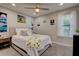 Cozy bedroom with neutral walls, a ceiling fan, and a comfortable bed with decorative pillows and throw at 6279 Lucille Dr # B, North Charleston, SC 29406