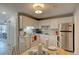 Bright kitchen with white cabinetry, stainless steel appliances, and breakfast nook area at 6279 Lucille Dr # B, North Charleston, SC 29406