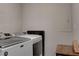 Neat laundry room featuring modern front-loading washer and dryer with a small wooden table at 6279 Lucille Dr # B, North Charleston, SC 29406