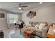 Inviting living room with modern furnishings, a ceiling fan, and large window at 6279 Lucille Dr # B, North Charleston, SC 29406