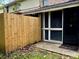 Exterior patio area with wood fence and access to the home through a screen door at 6279 Lucille Dr # B, North Charleston, SC 29406