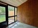 Relaxing sunroom with wood paneling and access to the backyard through a glass door at 6279 Lucille Dr # B, North Charleston, SC 29406