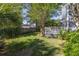 Picturesque backyard with a deck, lush grass, and mature landscaping providing a private outdoor oasis at 700 Preservation Pl, Mount Pleasant, SC 29464