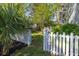 Charming backyard with a white picket fence and lush greenery at 700 Preservation Pl, Mount Pleasant, SC 29464